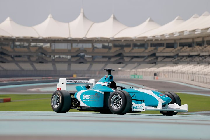 Feel the power of a racing car as you navigate the F1 track experiencing exhilarating speed and precision beneath the stunning Yas Viceroy hotel backdrop. An unforgettable adventure awaits.